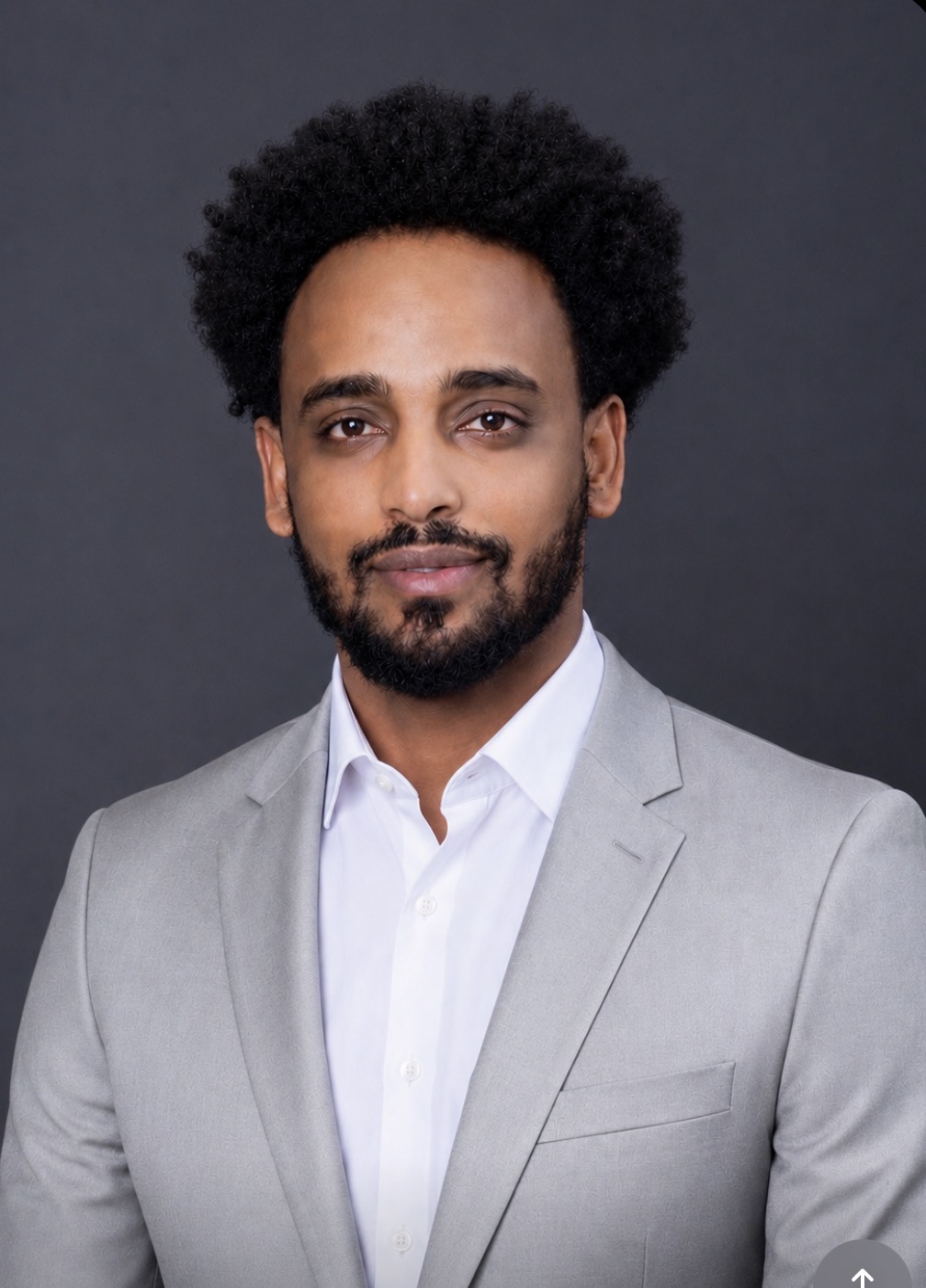 Professional portrait of a TBS Solutions representative in a light gray suit